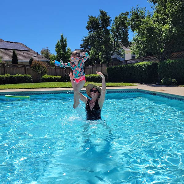 Woman with her daughter in pool